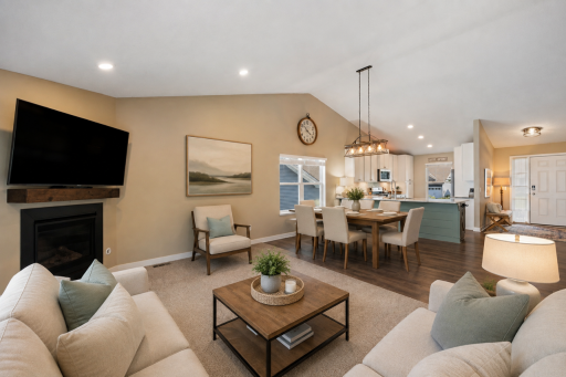 Living room open to the dining and kitchen. Virtually staged