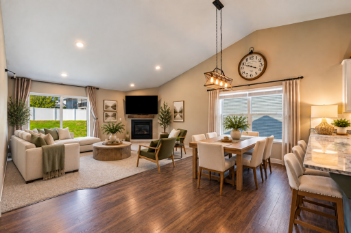 Living room open to the dining and kitchen. Virtually staged