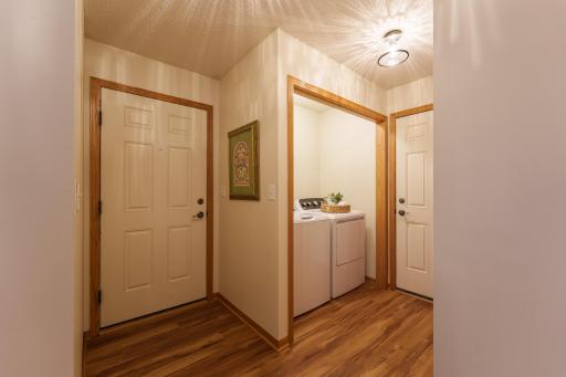 Door to the left is the side entrance. Door to the right is the garage entrance. Half bathroom is across the hall from laundry.