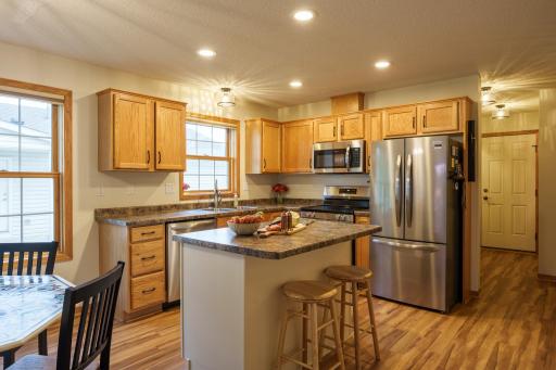 The kitchen features all new appliances (2026), LED recessed lighting, new light fixture, island painted in an attractive accent color, new sink & faucet and new cabinet door handles!