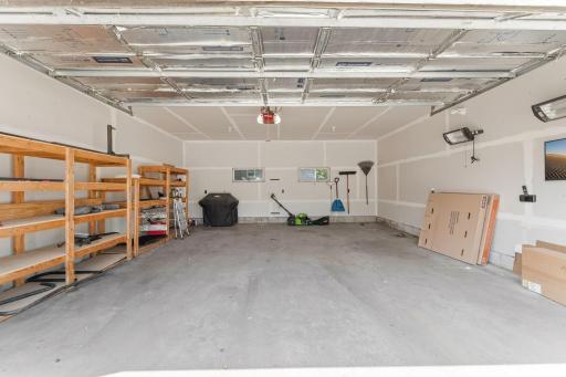 Extra large two-car garage with tall ceilings and ample storage room