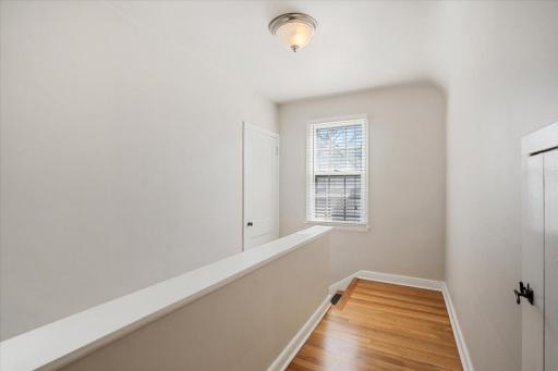 Upper level hall with door to attic storage.