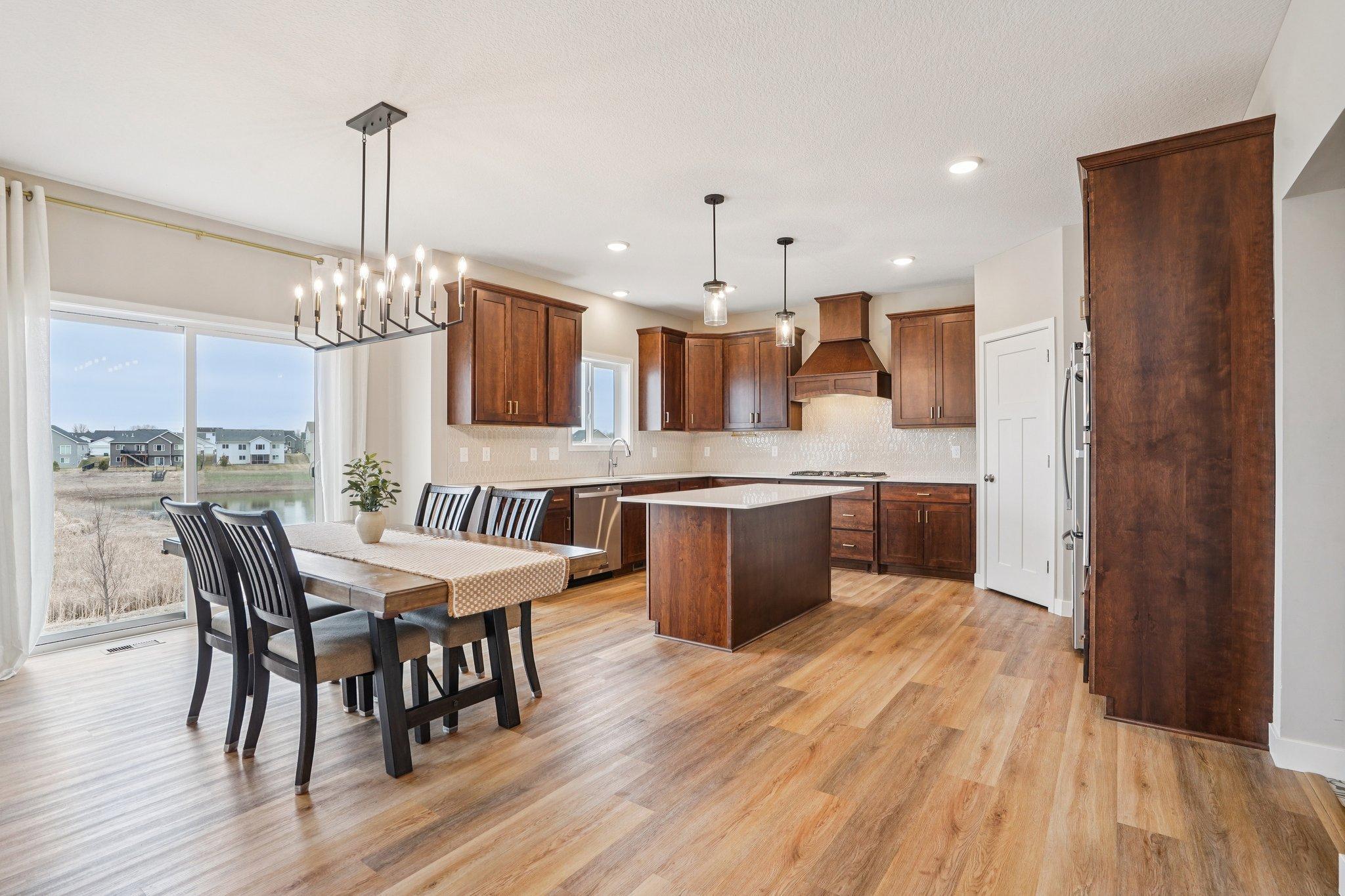 Gorgeous flooring, dark wood accents and white countertops!