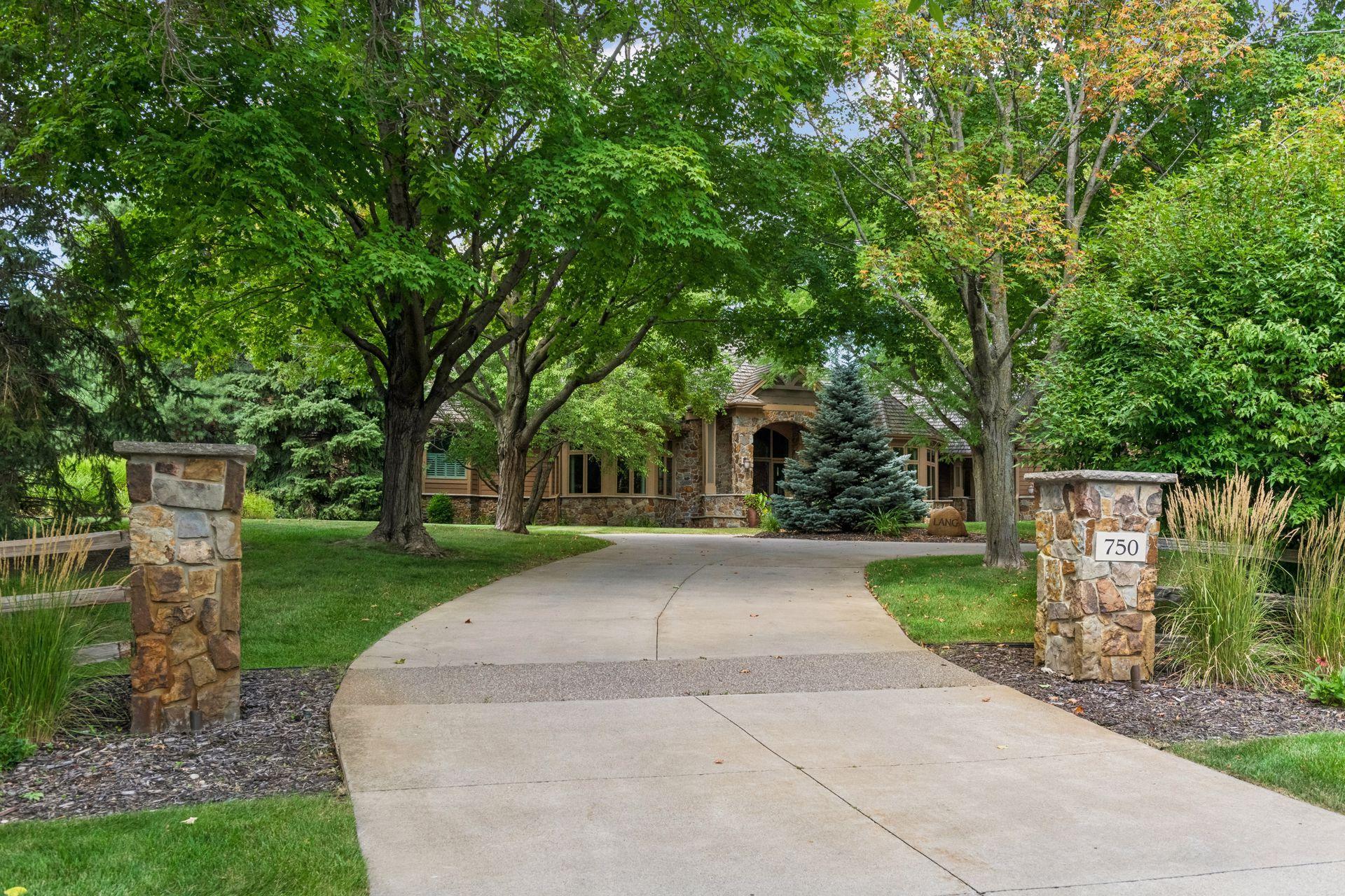 The concrete driveway leading up to the home and 5-car garage.