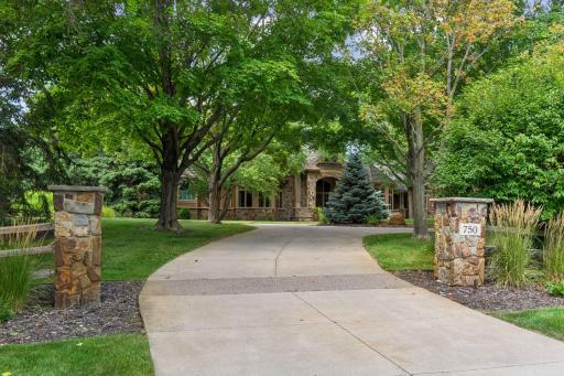 The concrete driveway leading up to the home and 5-car garage.