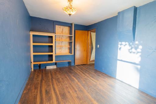 Main floor bedroom with built in book shelves