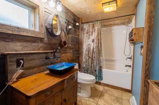 Custom built bathroom vanity and accent wall with barnwood