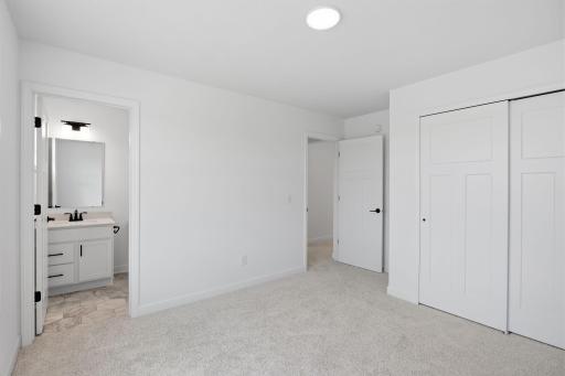 This secondary bedroom features an en-suite bathroom, making it a great space for overnight guests or household members that need more privacy.