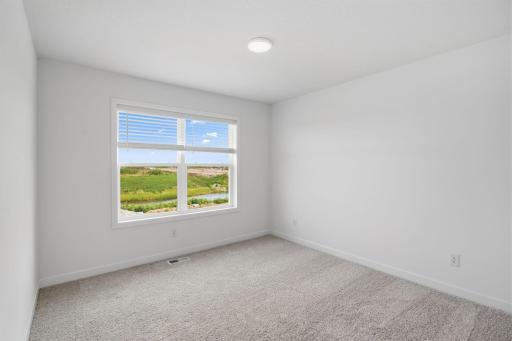 Three secondary bedrooms are located on the second floor.