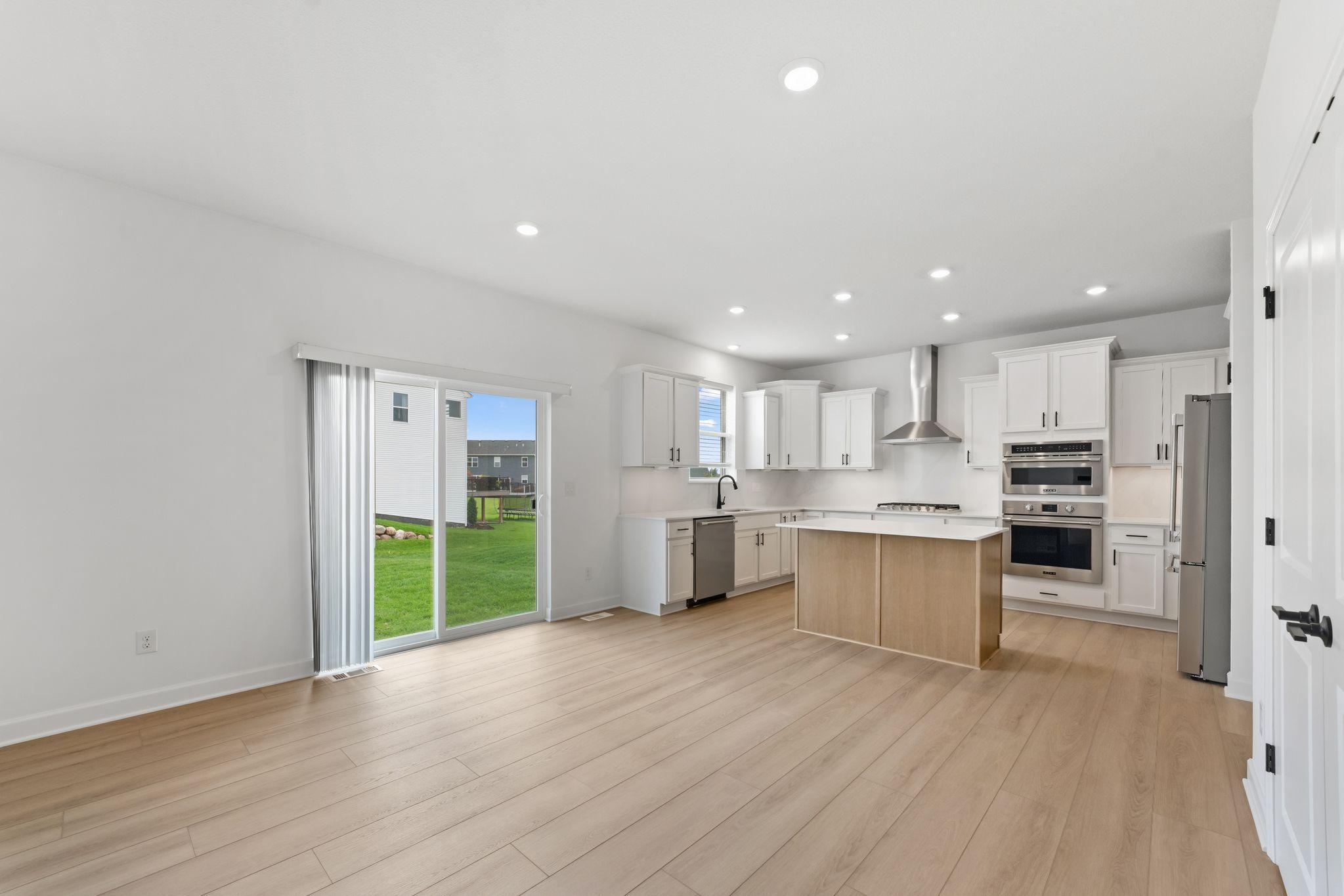 The center island has an open line of sight to the dining and living spaces