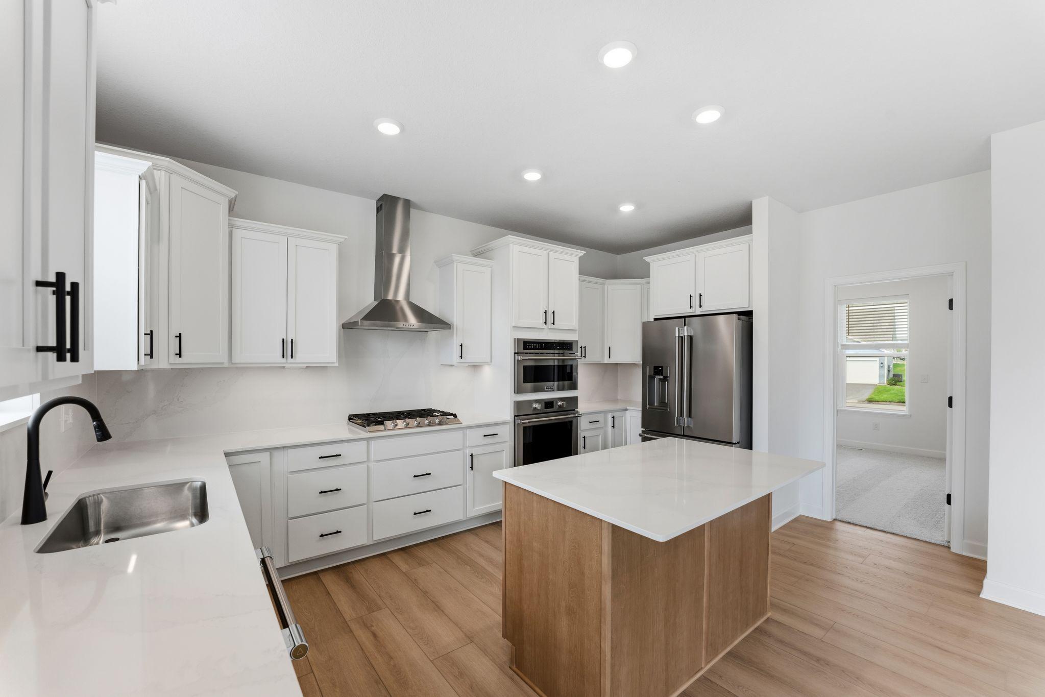 The center island extends out to a breakfast bar for casual meals