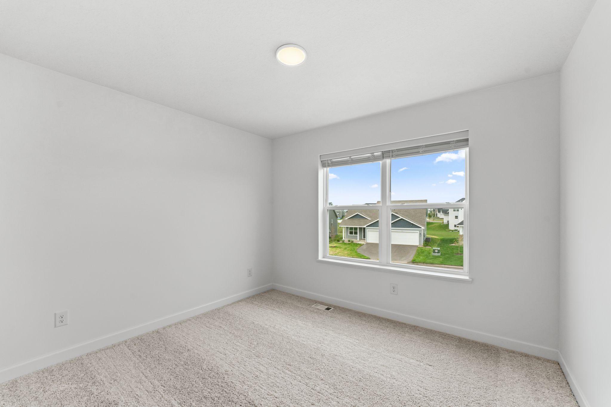 Three secondary bedrooms are located on the second level.