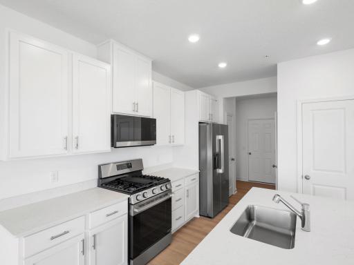 Durable and designer-selected countertops pair with stylish flat-panel cabinetry to help maintain an efficient kitchen