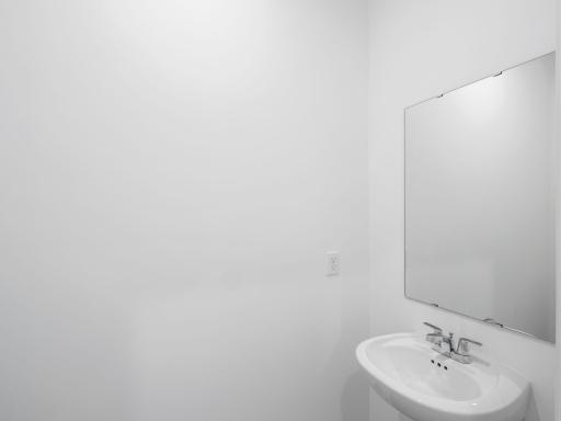 In a discreet location found off the kitchen, this powder room is readily available for residents and visitors to use to their convenience.