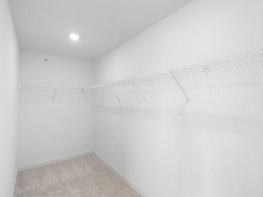 Accessible from the ownerâs suite bedroom, this oversized walk-in closet features built-in shelving to optimize wardrobe organization
