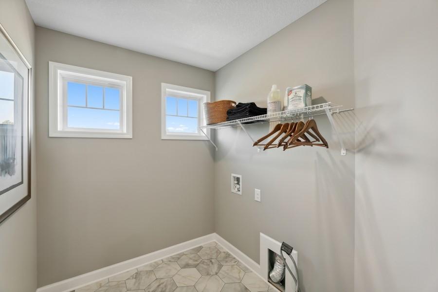 (Photo of decorated model, colors and features will vary) Upper level laundry is prepped for your appliances. The shelving is included.