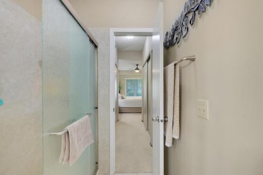Enjoy the newly remodeled step-in shower. The door leads you to two walls of primary bedroom closets.