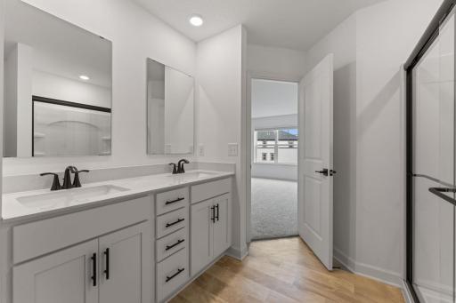 (Photo of a similar home, actual finishes may vary) Quartz countertops, MoenÂ® Glyde faucets and dual sinks come together at this impressive vanity