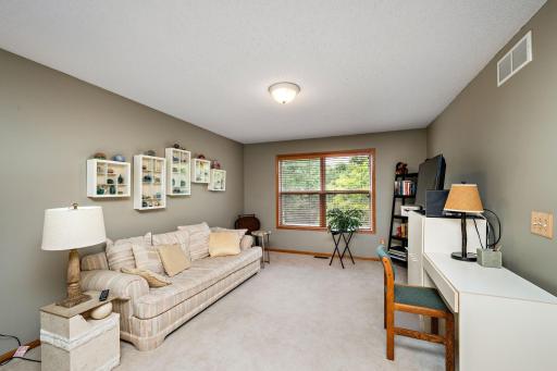 The upper family room/loft over looks the wooded rear area!