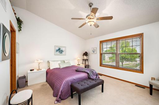The spacious primary suite has vaulted ceilings, a walk-in closet, and a wak-through bath!