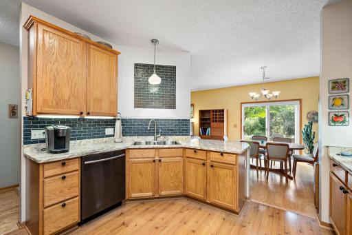 The granite serving counter has a breakfast bar and there is an attractive tile backsplash in the stove and sink areas!