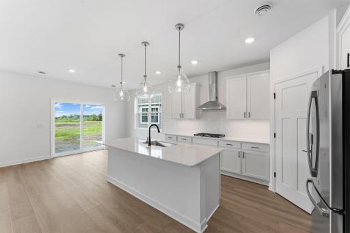 This multifunctional kitchen features a spacious center island that extends out to a breakfast bar, while brand-new appliances and plenty of storage help make food prep simple.