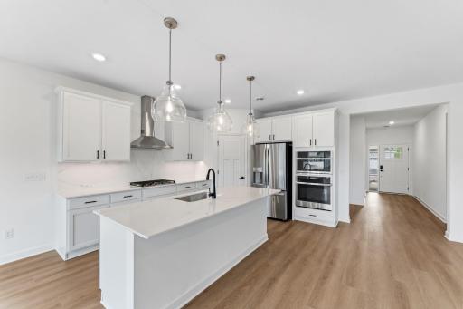 With plenty of cabinetry storage and a convenient corner pantry, everything is both within reach and out of sight at the same time