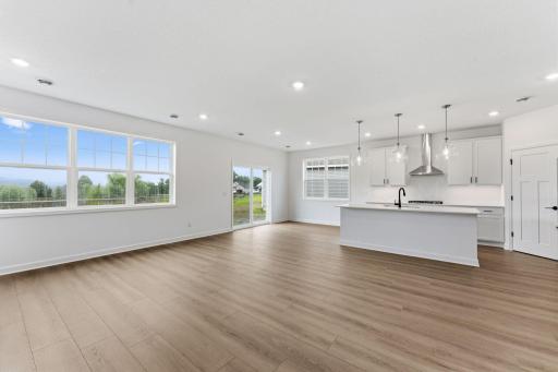 The dining room is situated among the open floorplan, promoting seamless flow between rooms.