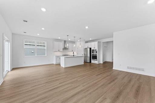 The dining room receives great natural light from the windows and glass sliders