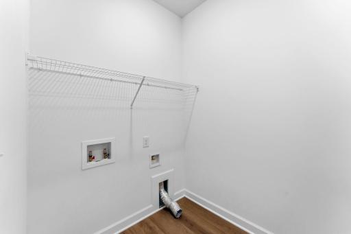 Enjoy easy chore days with an overhead shelf and connections for a washer and dryer in the laundry room.