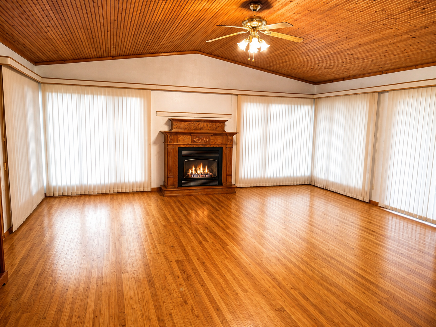 A Show-Stopping Great Room! Vaulted ceiling lined in rich, warm wood create sun-drenched brilliance. Floor-to-ceiling windows capture every drop of natural light - dawn until dusk. Wood floors anchor the space, reflecting the sun throughout the day