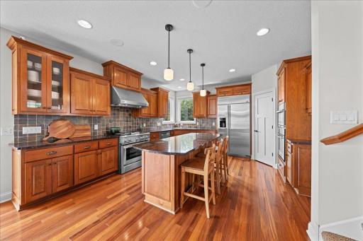 This kitchen has it all!! Cherry wood cabinetry, backsplash, etc...