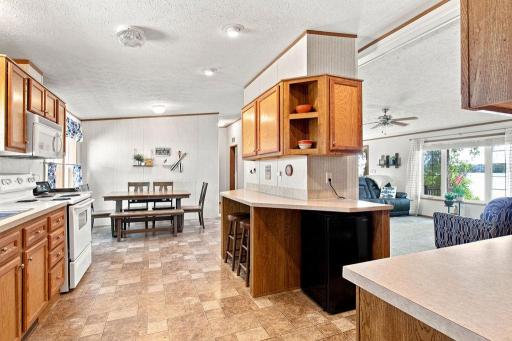 Kitchen features an option to eat-in at the counter and lots of cabinetry for storage