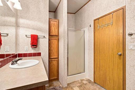 Shower and Linen Closet in the Primary Bathroom