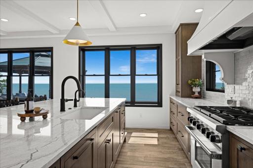 An exceptional kitchen designed for both serious cooking and effortless gathering, with Wolf and Sub-Zero appliances, a remarkable uninterrupted Cambria surface and Lake Superior as the backdrop.