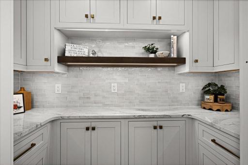The “too-pretty-to-hide” pantry—tucked just off the kitchen and finished with custom cabinetry, beautiful surfaces and the same level of craftsmanship as the kitchen itself.