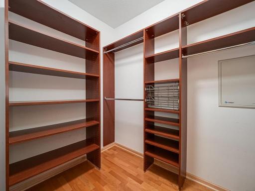 The large, walk-in hallway closet features a customized closet system.