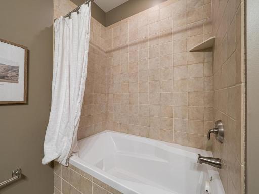 The guest bath features a soaking tub, shower combination.
