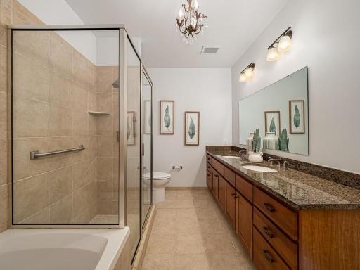 The primary bathroom ensuite offers a dual sink vanity with large counter space a separate walk-in shower and soaking tub.