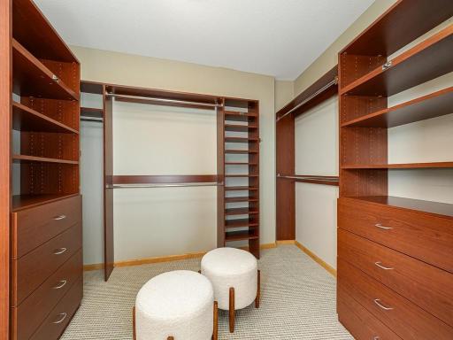The primary bedroom features a large, customized walk-in closet and bathroom ensuite.