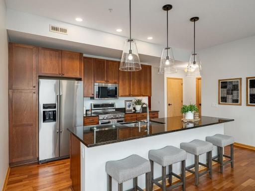The kitchen features granite countertops and an expansive island with comfortable seating for 4.