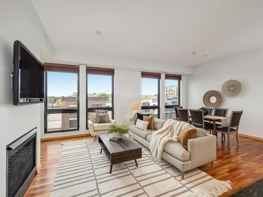 The open floor plan boasts 10ft ceilings, floor-to-ceiling windows, elegant Brazilian cherry hardwood flooring through out the living room, dining area and den and a gas fireplace.
