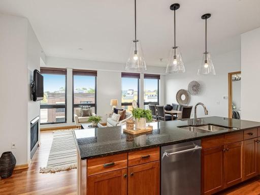 The view from the kitchen is highlighted with south-facing floor to ceiling windows and visual access to the living and dining areas.