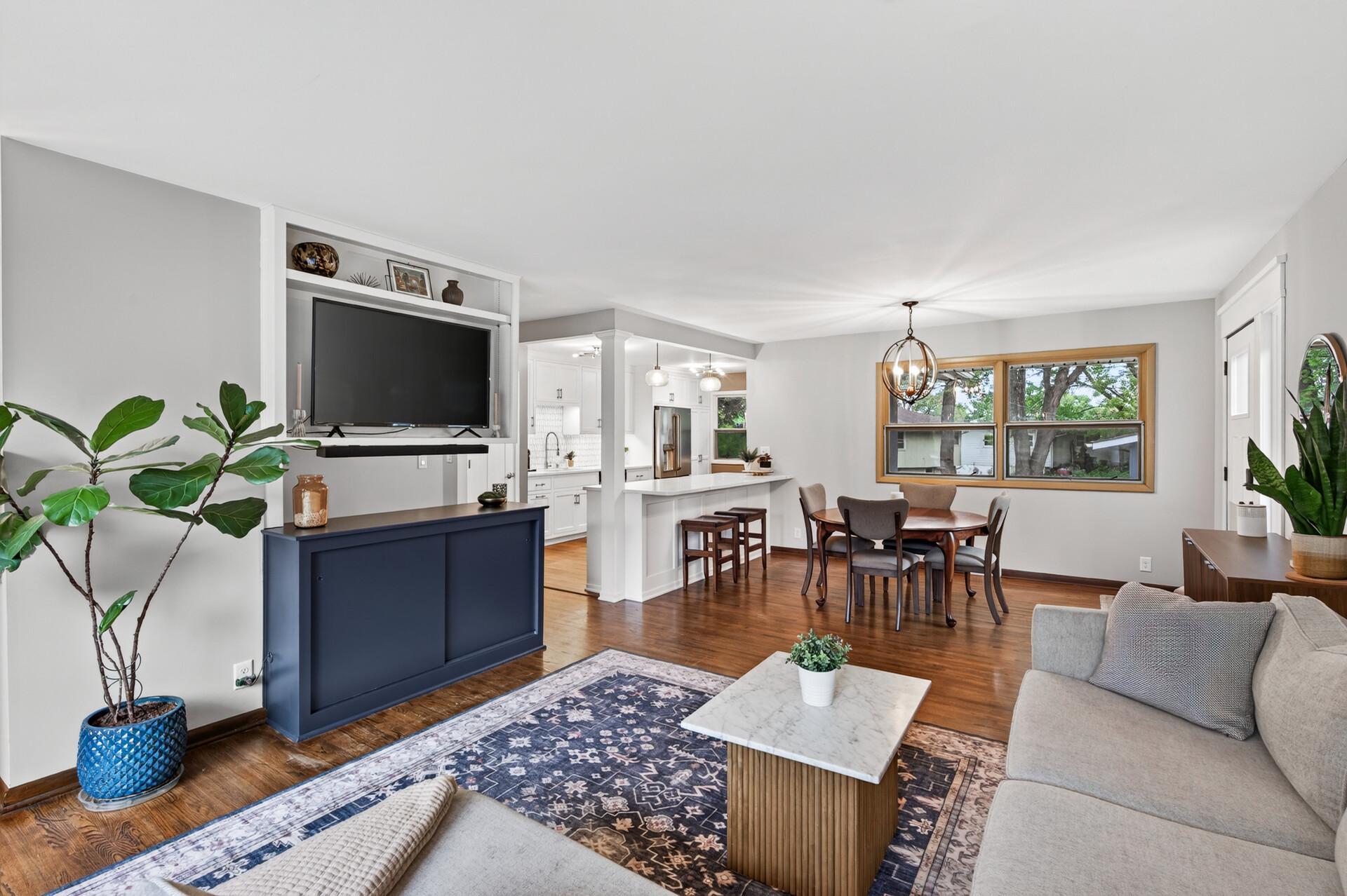Open main level with a spacious living room, dining space, and kitchen