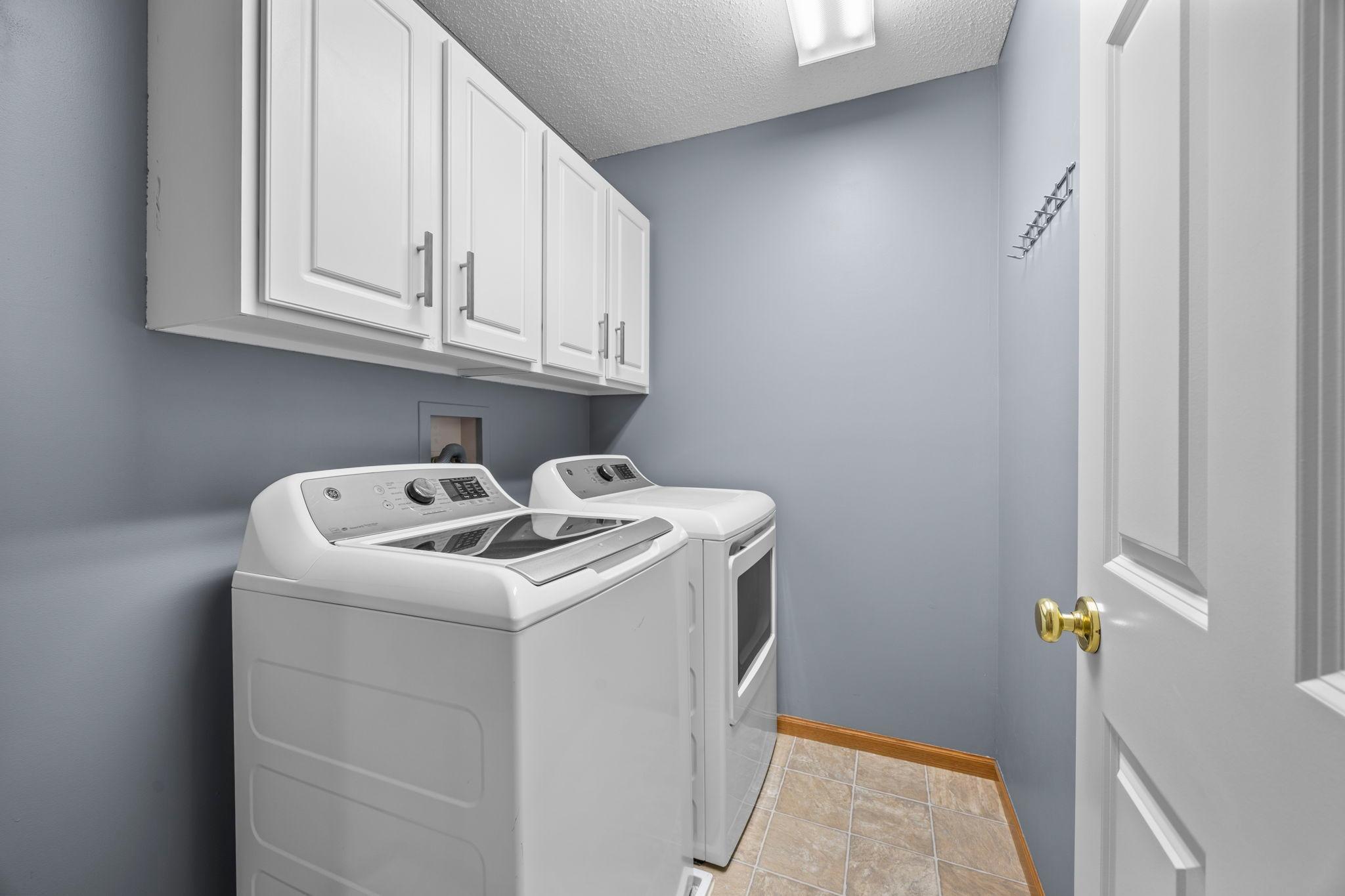 Upper-level laundry is also close by, making everyday routines a little easier. It includes a GE washer and dryer, cabinetry, and additional hall closet storage.