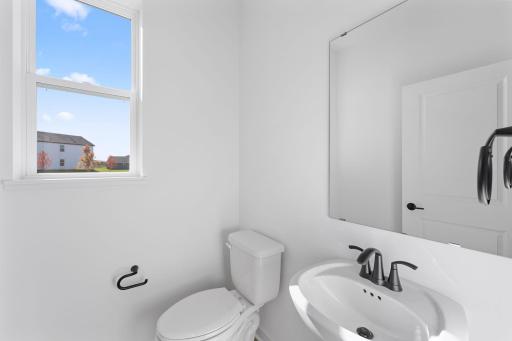 Found off the Great Room is a convenient powder room to meet the needs of the whole household, as well as visiting guests.
