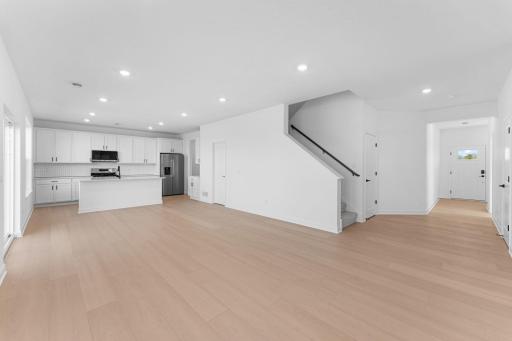 Shaw luxury vinyl plank flooring runs throughout the foyer, Great Room and other select parts of the home