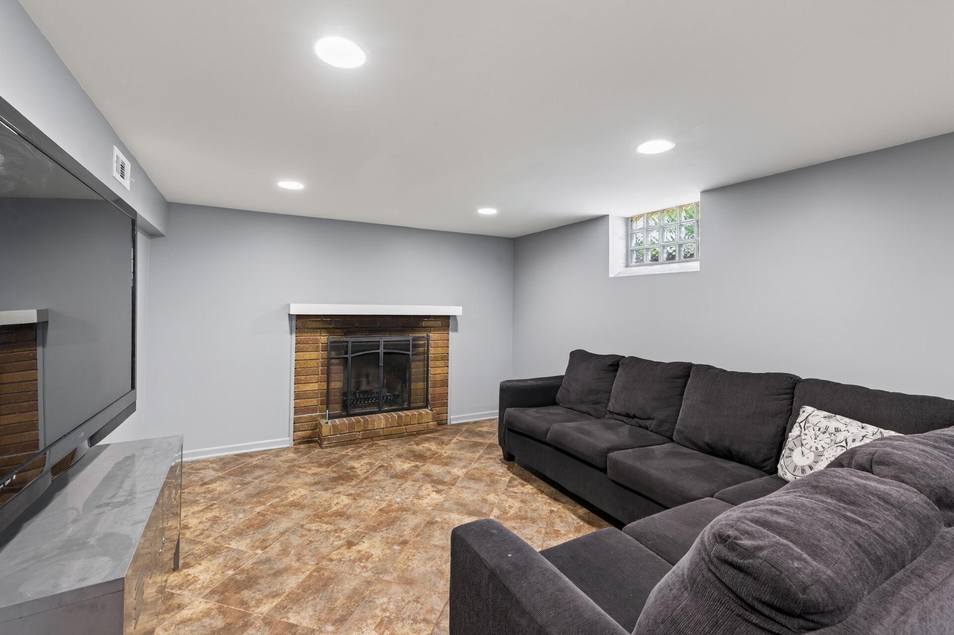 Family room downstairs with a second wood burning fireplace