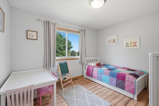 The second spacious bedroom offers peaceful views of the rear yard and generous closet space.