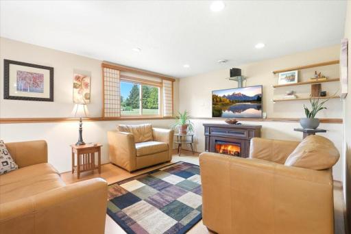 The second gathering space is perfect for movie nights or game nights alike! A glowing electric fireplace, which will stay with the home, adds a warm and inviting touch to the space—creating the perfect ambiance.